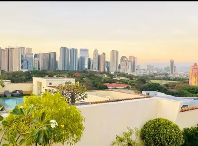 a view of a city skyline from a building at Cozy Corner Haven near Venice Grand Canal Mall in Manila