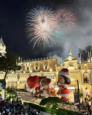 a fireworks display in front of a building with people at Cozy Corner Haven near Venice Grand Canal Mall in Manila