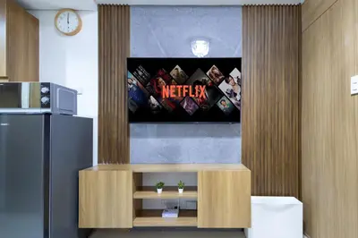 a television on a wall in a room at Lush Residences Makati in Manila