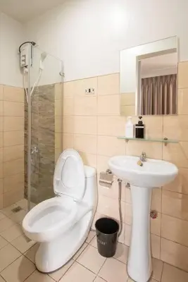 a bathroom with a toilet and a sink at St. Marvin Studio Makati M406 in Manila