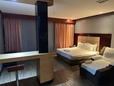 a hotel room with a bed and a couch at Jjimjbang hotel spa in Manila