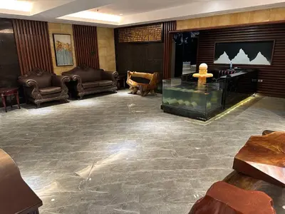 a lobby with couches and a tv in a room at Jjimjbang hotel spa in Manila