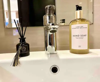 a bathroom sink with a bottle of hand sanitizer on it at Airport NAIA Terminal 3 Insane Interior in Manila