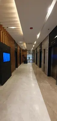 an empty hallway in a building with a tv on the wall at C Place - Capsule A in Manila