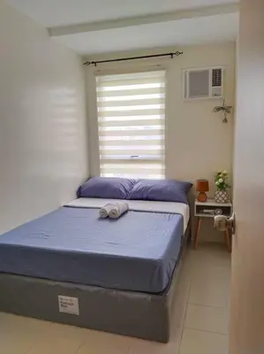 a bedroom with a bed and a window at 2BR Condo by Coco's Haven in Manila