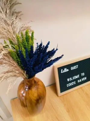 a brown vase with plants in it on a table at 2BR Condo by Coco's Haven in Manila