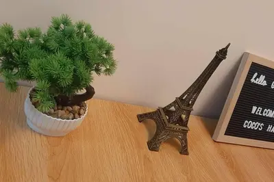 a plant and a statue of the eiffel tower on a table at 2BR Condo by Coco's Haven in Manila