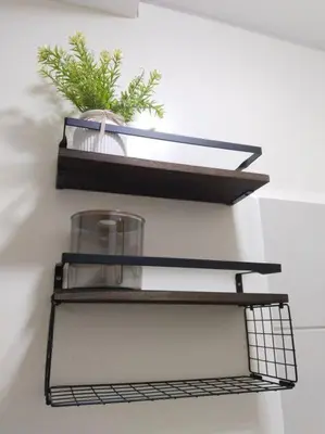 a black shelf with a plant on a wall at 2BR Condo by Coco's Haven in Manila