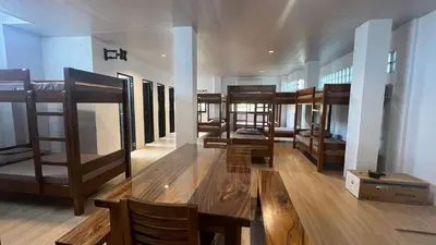 a room with several bunk beds and a table at CD NATUREVIEW in Matangtubig