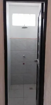 a bathroom with a shower with a glass door at CD NATUREVIEW in Matangtubig