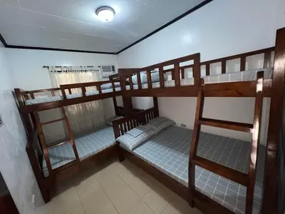 a bedroom with two bunk beds in a room at CD NATUREVIEW in Matangtubig