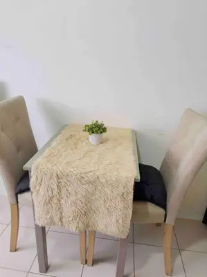 a table and two chairs with a potted plant on it at Modern style Condo with Unli Wifi and Netflix in Manila