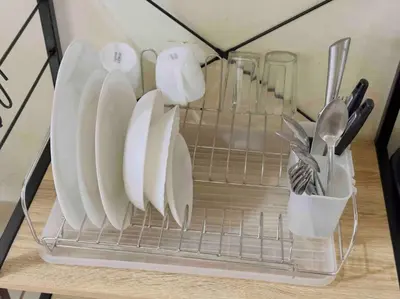 a rack with plates and utensils on a table at Modern style Condo with Unli Wifi and Netflix in Manila