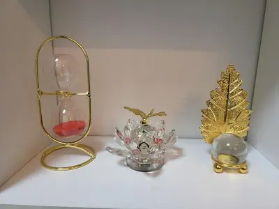 a shelf with a glass vase and a christmas tree at SHORE 3 TOWER 1 Mall of Asia- Casa Sandique in Manila