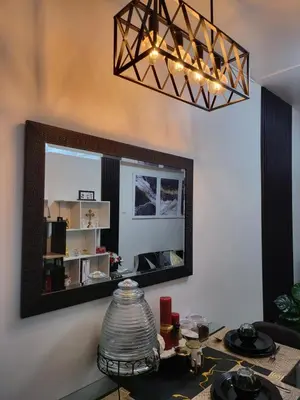 a mirror on the wall of a room with a table at SHORE 3 TOWER 1 Mall of Asia- Casa Sandique in Manila