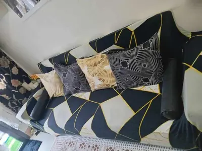 a bed with four pillows on top of it at SHORE 3 TOWER 1 Mall of Asia- Casa Sandique in Manila