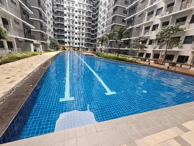 an empty swimming pool in a building with tall buildings at SHORE 3 TOWER 1 Mall of Asia- Casa Sandique in Manila