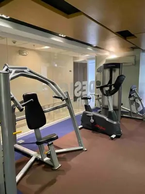 a gym with two exercise bikes and a treadmill at Modern 1BR apartment in Manila
