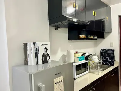 a kitchen with a counter top with a microwave at Staycation Condotel Room to Stay Paranaque in Manila