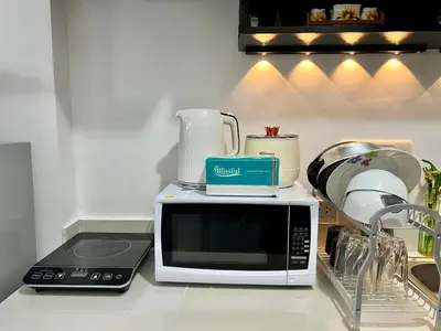 a kitchen counter with a microwave and other appliances at Staycation Condotel Room to Stay Paranaque in Manila
