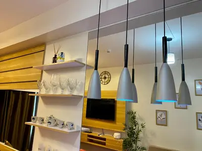 a kitchen with several lights hanging from a wall at Woodland Elegance Retreat Symphony of Artistry with Blazing fast 300 Mbps in Manila