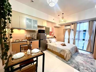 a bedroom with a bed and a table in it at Condo Unit Viceroy Residences Mckinley Hill cd22b in Manila
