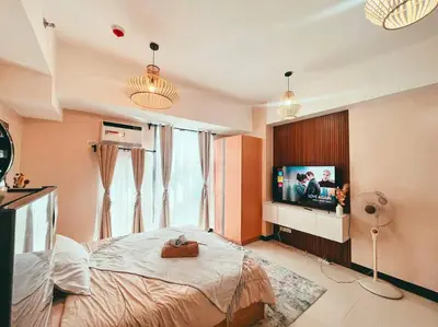 a bedroom with a bed and a flat screen tv at Condo Unit Viceroy Residences Mckinley Hill cd22b in Manila