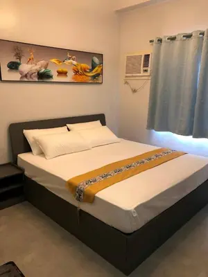 a large bed in a room with a window at COCO STAR HOTEL in Manila