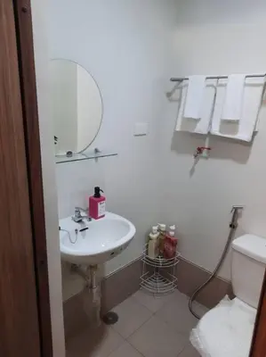 a white bathroom with a sink and a toilet at SMDC Spring Malachai's place in Manila
