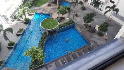 an overhead view of a large pool with people in it at SMDC Spring Malachai's place in Manila