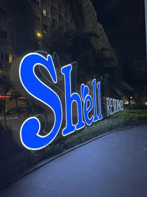 a neon sign that says sitz relief rescue at Aiza's CondoTel in Shell Residences near MOA and NAIA in Manila