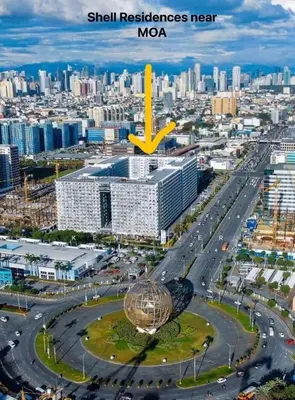 an aerial view of a city with a skyscraper at Aiza's CondoTel in Shell Residences near MOA and NAIA in Manila