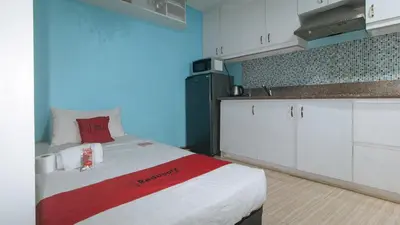 a small kitchen with a bed in a room at RedDoorz at TJMG by Bel Air Polaris Makati in Manila