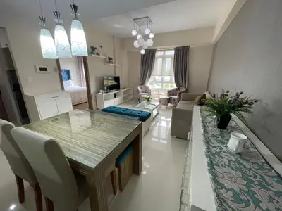 a kitchen and living room with a table and chairs at 150 Newport Boulevard, near Terminal3 Airport in Manila