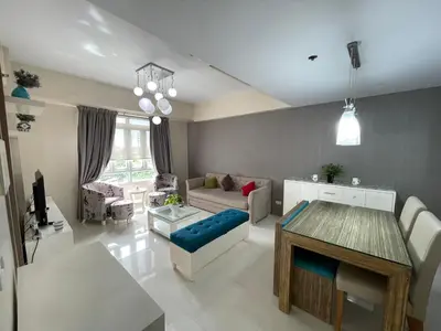 a living room with a couch and a table at 150 Newport Boulevard, near Terminal3 Airport in Manila