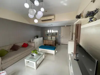 a living room with a couch and a table at 150 Newport Boulevard, near Terminal3 Airport in Manila