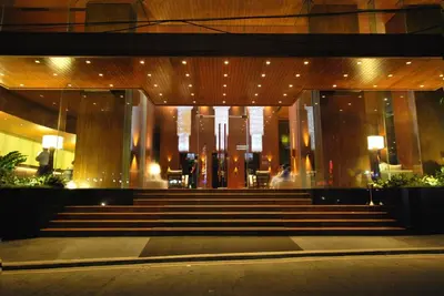a lobby of a building with stairs and lights at City Garden Grand Hotel in Manila