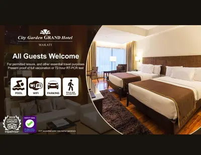 a hotel room with two beds and a couch at City Garden Grand Hotel in Manila