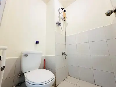 a bathroom with a toilet and a shower at Fancy Condo with Unli Wifi and Netflix in Manila