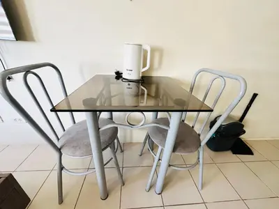 a glass table with two chairs and a blender on it at Fancy Condo with Unli Wifi and Netflix in Manila
