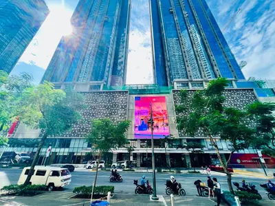 a tall building with people riding motorcycles in front of it at MODERN BGC 1BR, Uptown Mall Connector, 5G WiFi, Pool, Ste 17 in Manila