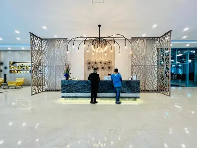 two men standing at a wine bar in a lobby at MODERN BGC 1BR, Uptown Mall Connector, 5G WiFi, Pool, Ste 17 in Manila