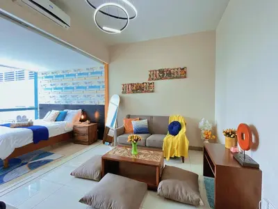 a bedroom with a bed and a living room with a couch at MODERN BGC 1BR, Uptown Mall Connector, 5G WiFi, Pool, Ste 17 in Manila