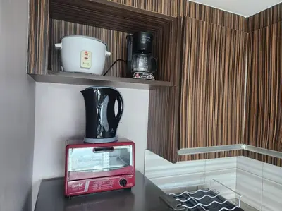a red microwave sitting on top of a table at KL Tower Cosy Studio with Balcony Sauna Gym Pool near Greenbelt in Manila