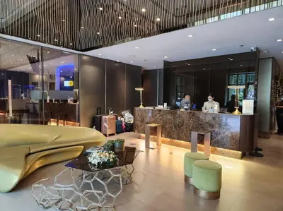 a lobby of a restaurant with a bar in the background at KL Tower Cosy Studio with Balcony Sauna Gym Pool near Greenbelt in Manila