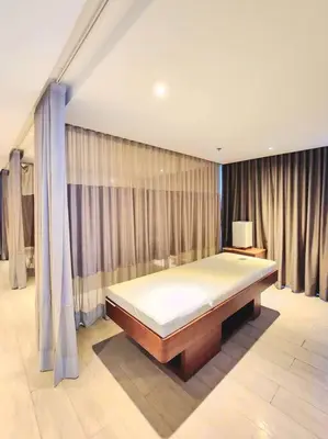 a bedroom with a bed in a room with curtains at BGC Cosy Spacious 1BR Uptown Parksuites with Balcony in Manila