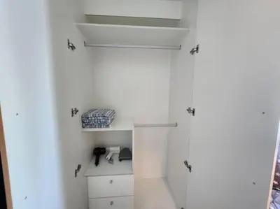 a bathroom with white walls and a white refrigerator at BGC Cosy Spacious 1BR Uptown Parksuites with Balcony in Manila