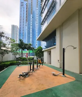 a group of benches in front of a building at BGC Cosy Spacious 1BR Uptown Parksuites with Balcony in Manila