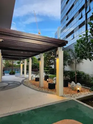 a building with a pavilion in front of a building at Cosy BGC Uptown Parksuites with Nice Balcony City View and Ultra Fast Internet 300mbps in Manila