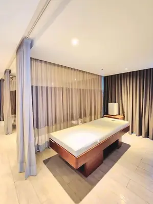 a bedroom with a bed in a room with curtains at Cosy BGC Uptown Parksuites with Nice Balcony City View and Ultra Fast Internet 300mbps in Manila